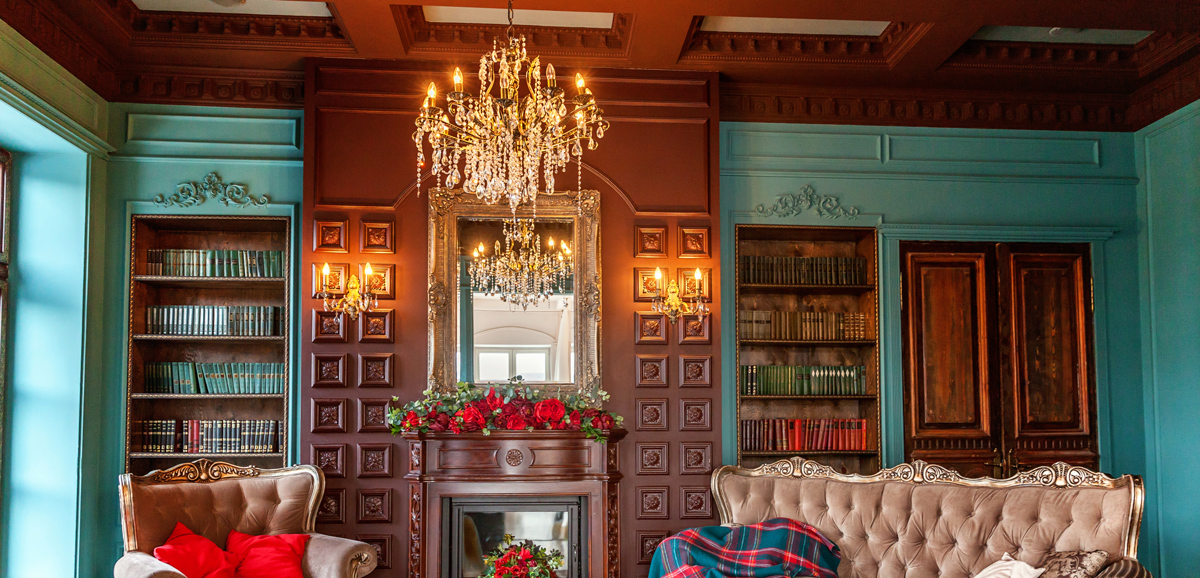 Sitting room in Victorian home with bold blue paint and historic wood trim preserved
