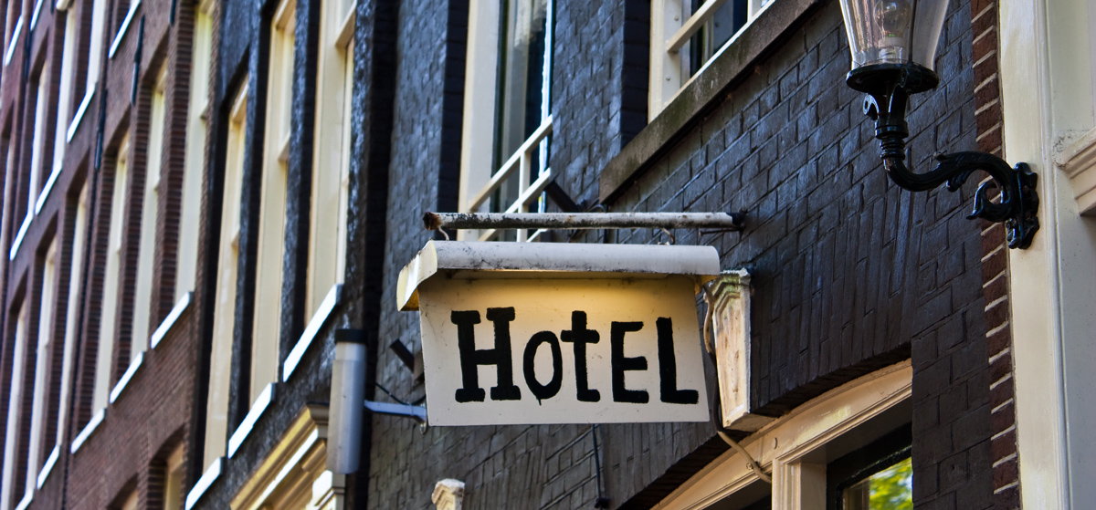 Hotel on small town main street with painted brick exterior