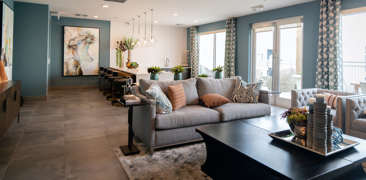 A tasteful high-end interior with rich blue accent walls and open floor plan living area