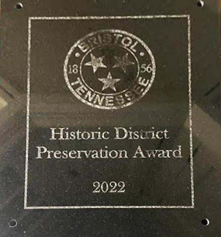Photo of 2022 Historic District Preservation Award marble plaque awarded to a Helpful Company client
