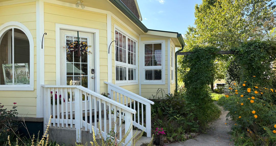 Back entry to addition on a historic Greeneville home with fresh paint yellow with white trim